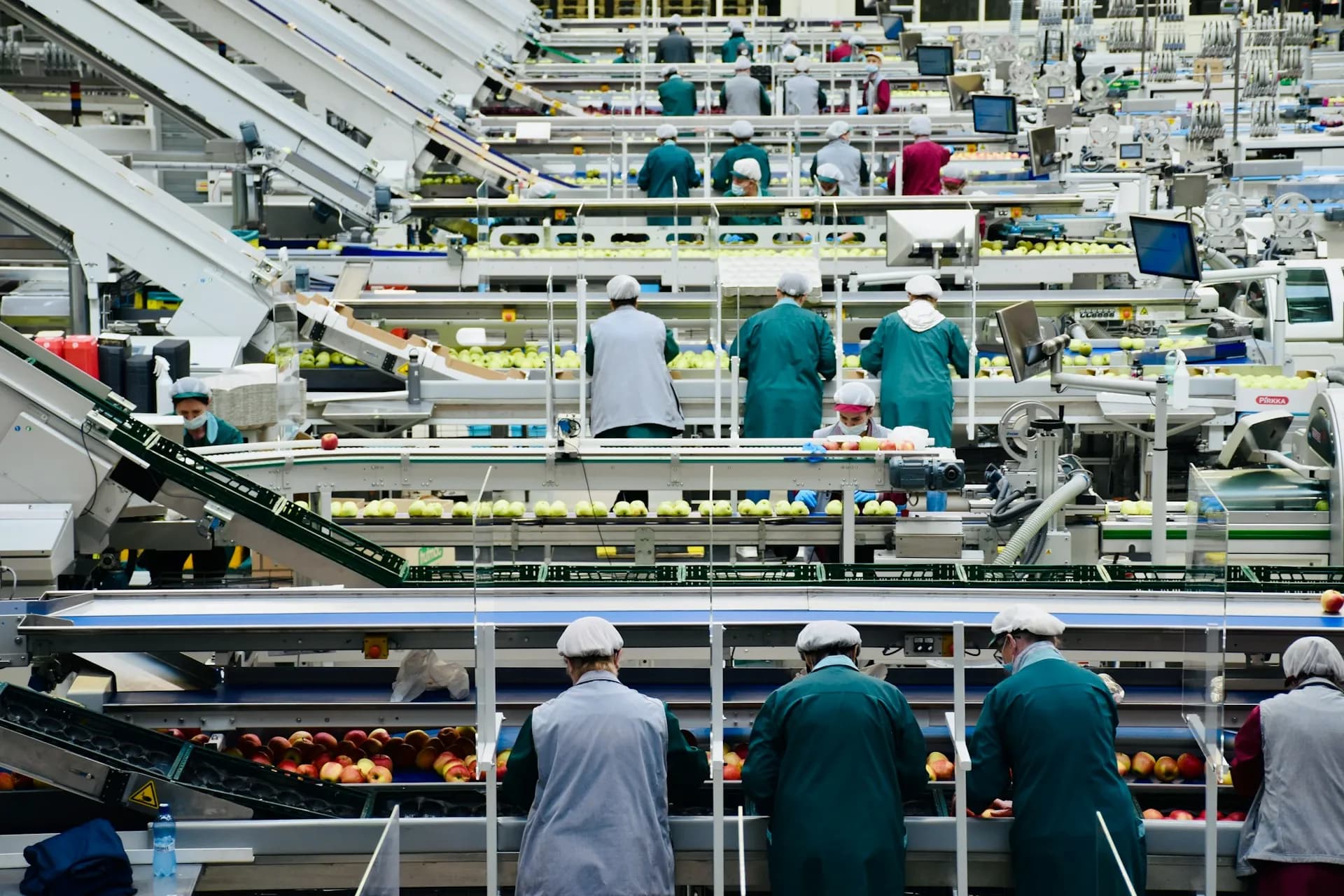 A prodduction facility with people working on an assembly line 