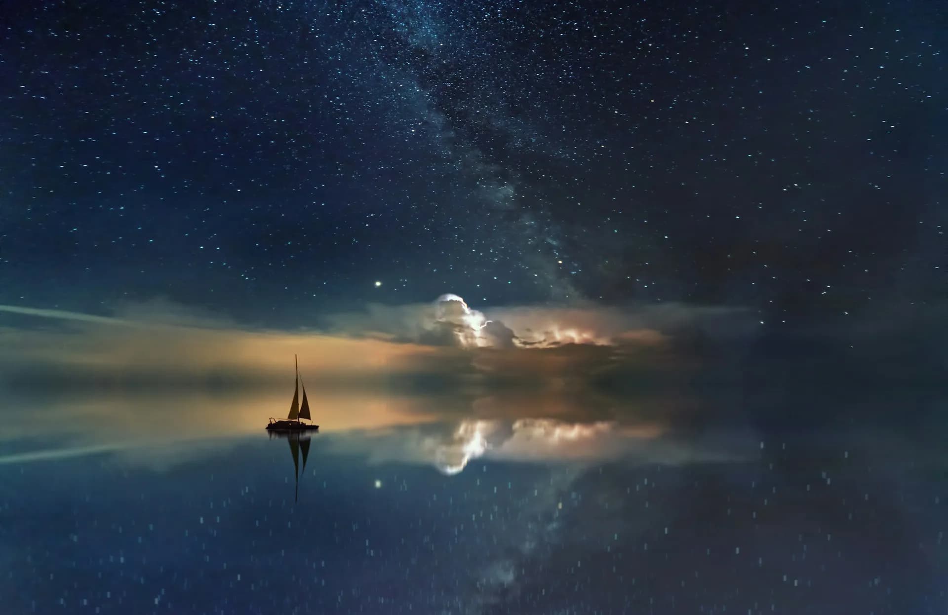 A sailboat sailing into the night