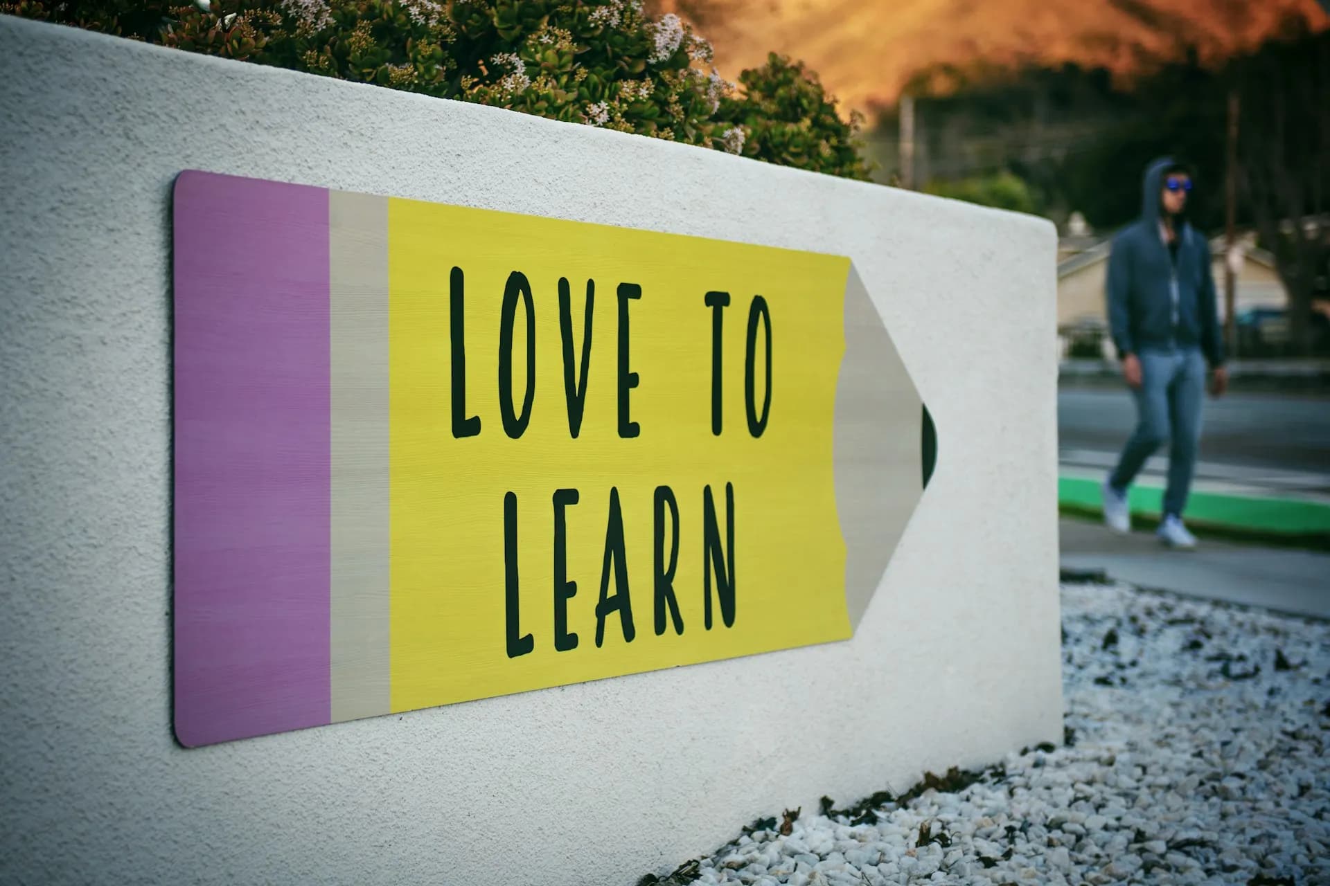 A sign on a wall saying Love To Learn